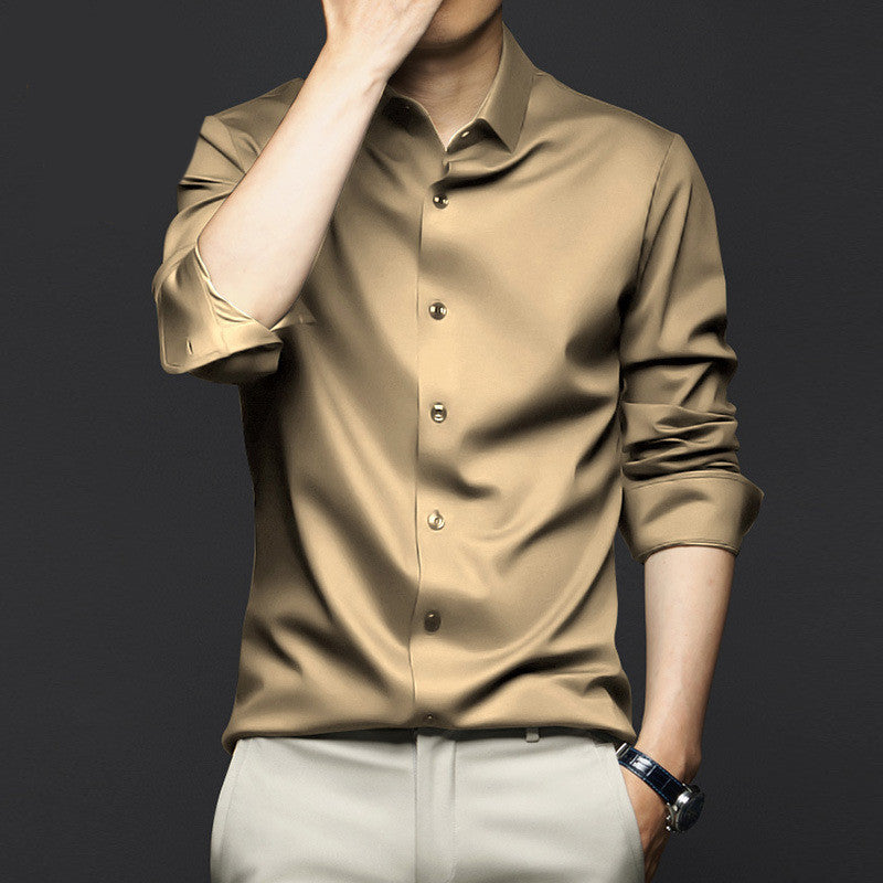 Man wearing rolled-up sleeves beige satin shirt with light gray pants and a wristwatch