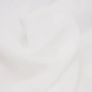 Close-up of soft white fabric texture, smooth and flowing cloth material