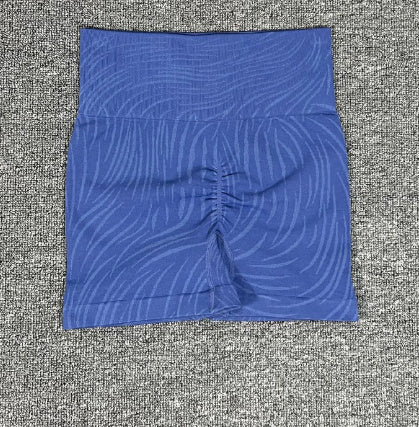 blue high-waisted athletic shorts with textured wavy pattern on gray fabric background