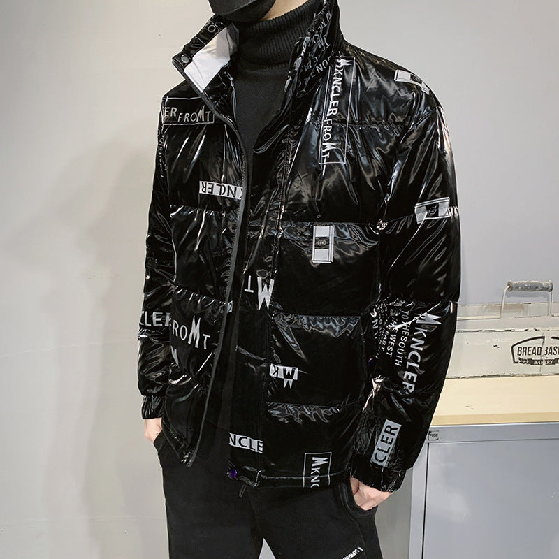 Person wearing shiny black Moncler puffer jacket with white branding and black turtleneck indoors