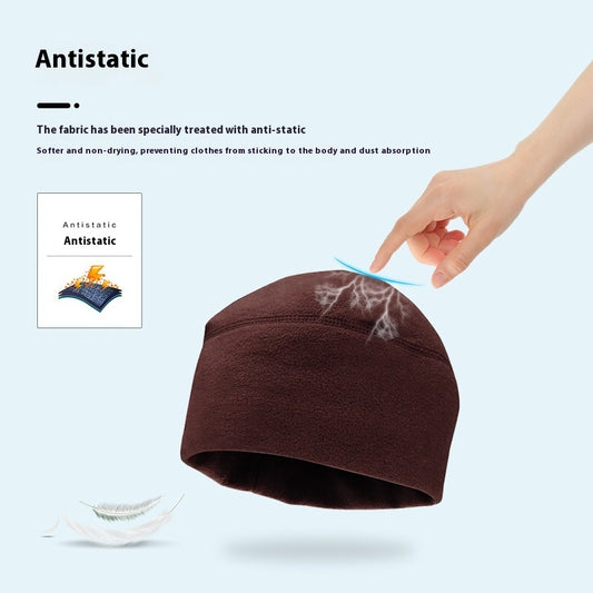 Brown antistatic hat with hand showing static electricity effect on light blue background