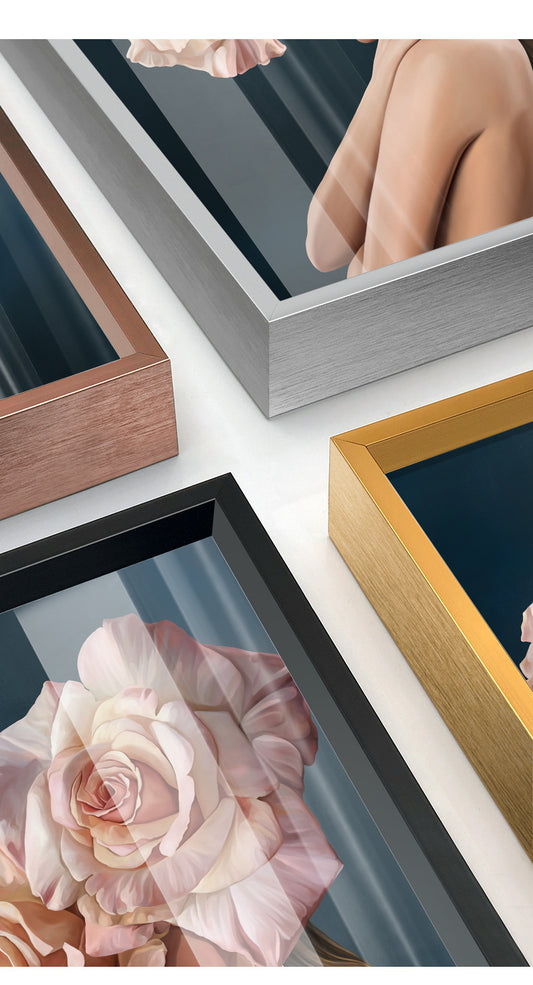 Close-up of modern metal photo frames in copper, silver, black, and gold showcasing floral and human art prints