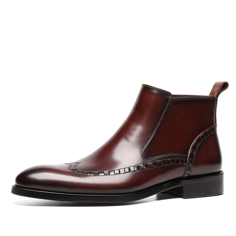 Brown leather Chelsea boot with decorative stitching and low heel on white background