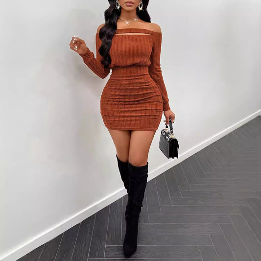 Woman in a rust-colored ribbed off-shoulder bodycon dress with black knee-high boots and a black handbag