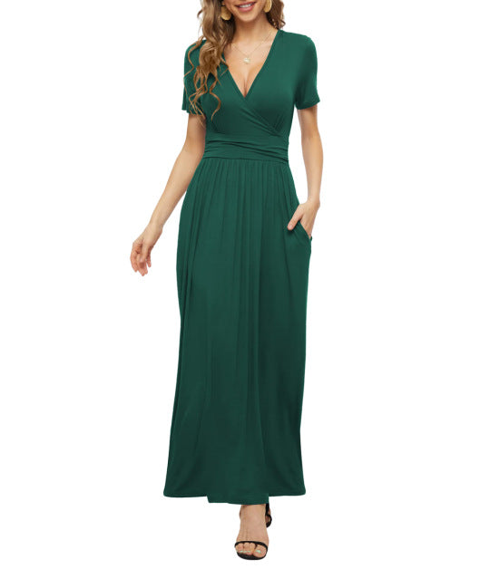 Woman wearing elegant dark green V-neck short sleeve maxi dress with side pockets and black heels