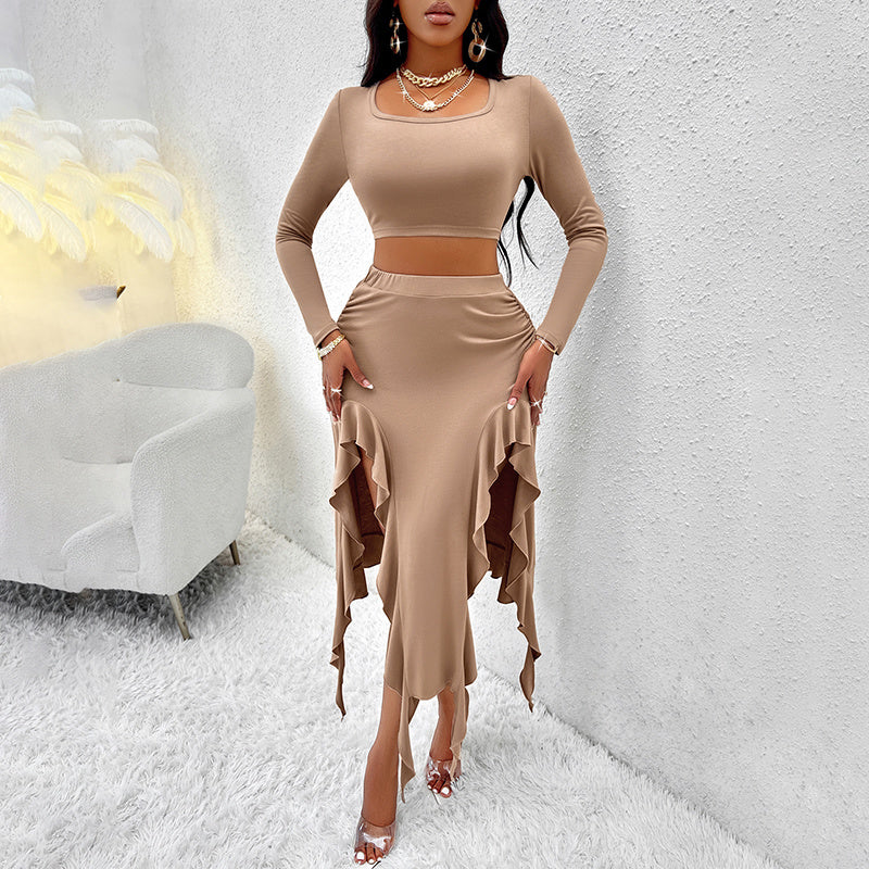 Woman in beige long-sleeve crop top and ruffled high-low skirt in modern white textured room