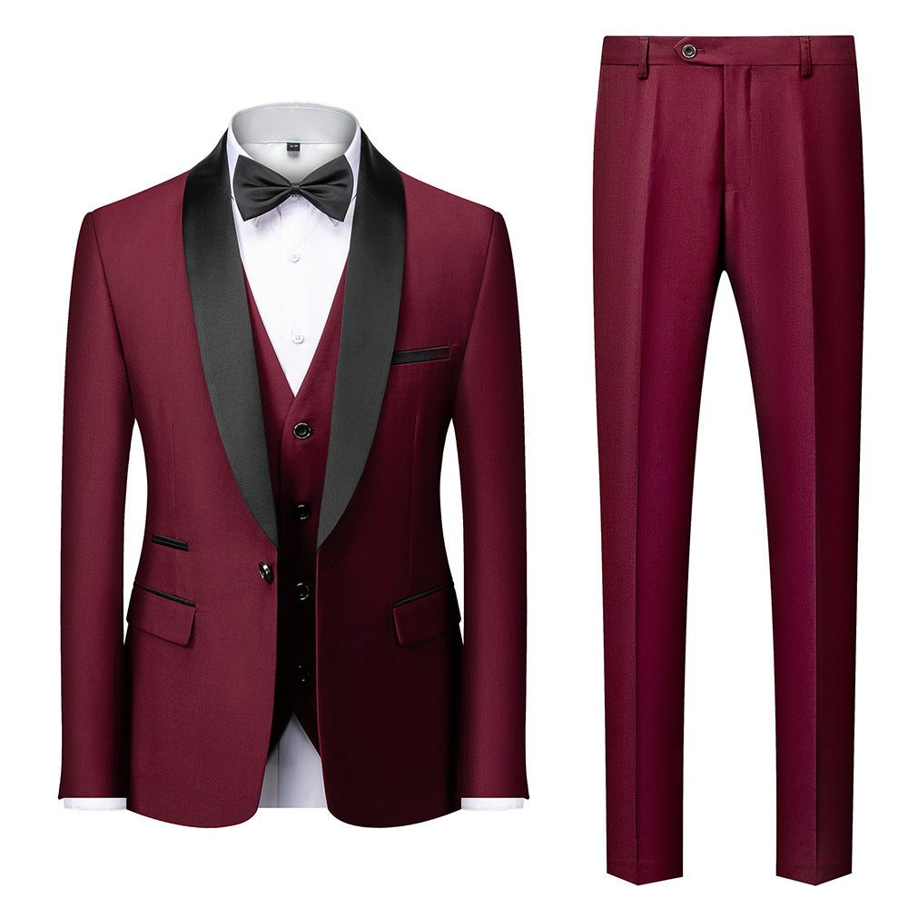 Men's burgundy tuxedo suit with black satin shawl lapel, matching vest, white dress shirt, black bow tie, and burgundy pants