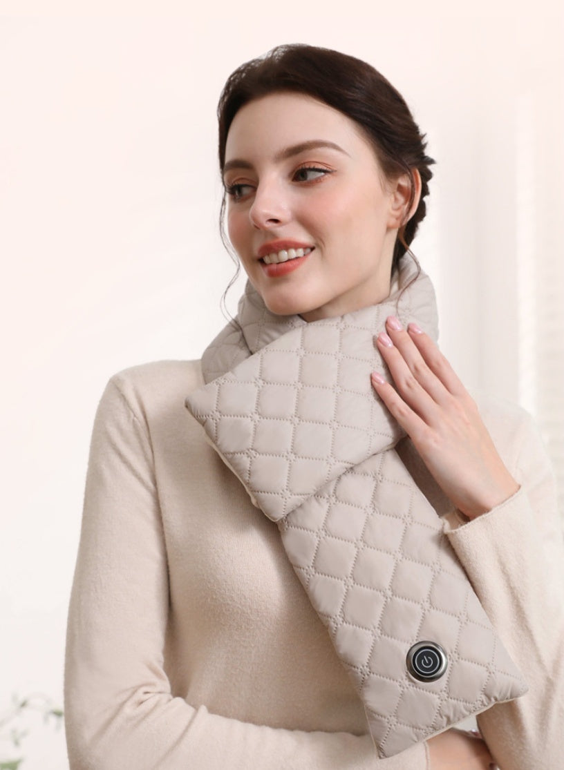 Woman wearing beige quilted heated scarf with power button, smiling indoors, cozy winter accessory