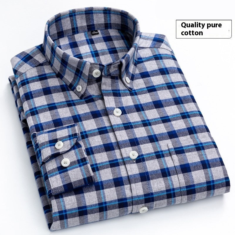 Folded blue and gray plaid cotton shirt with buttoned collar and cuffs on white background