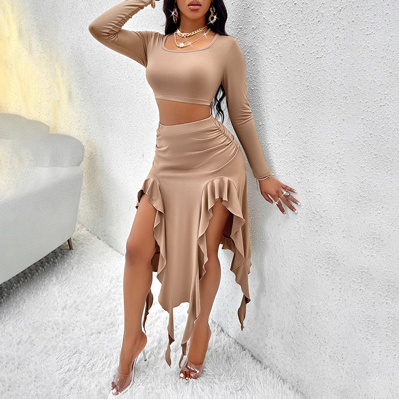 woman wearing beige long sleeve crop top and asymmetrical ruffled skirt with high slits