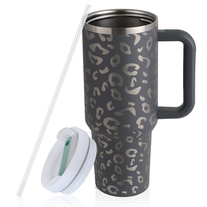 Gray leopard print travel mug with handle, white lid, and reusable straw on white background