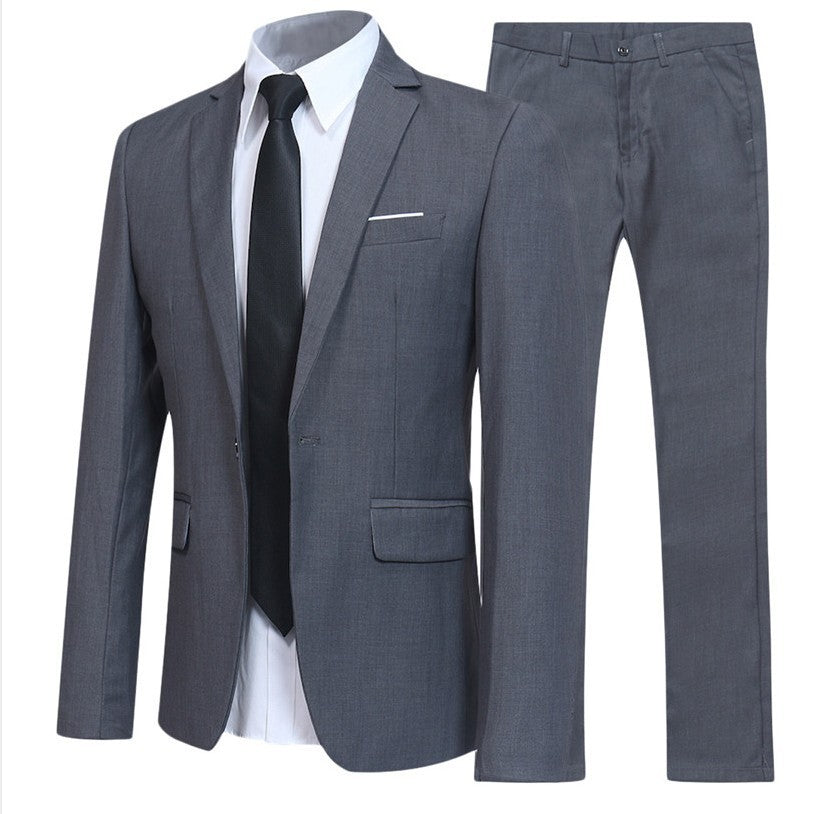Gray men's suit set with blazer, matching trousers, white dress shirt, and black tie on white background