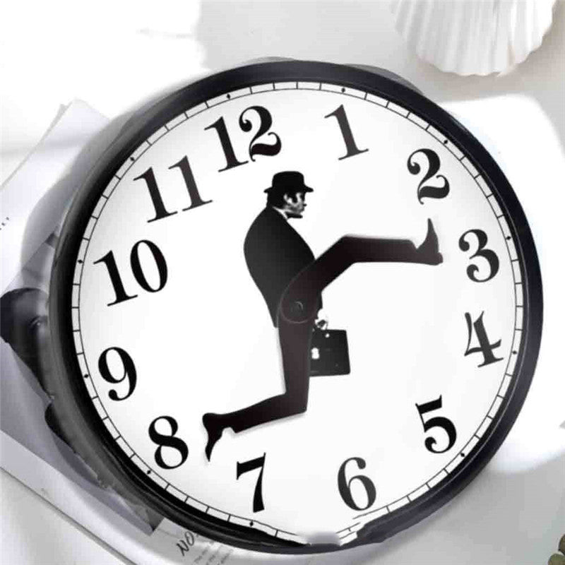 Round wall clock featuring a black silhouette of a man in a hat and briefcase as the clock hands