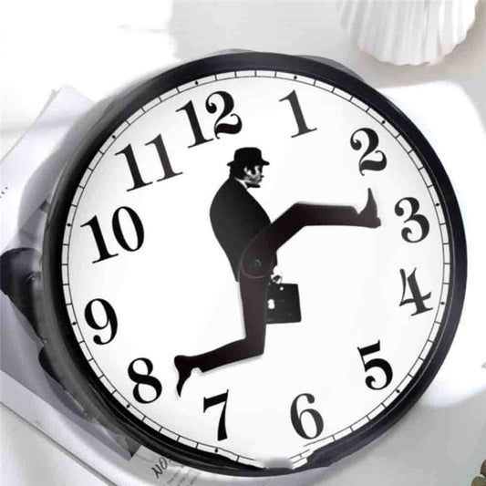Round wall clock featuring a black silhouette of a man in a hat and briefcase as the clock hands