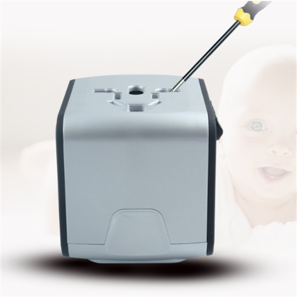 Universal travel adapter with screwdriver on top and blurred baby background