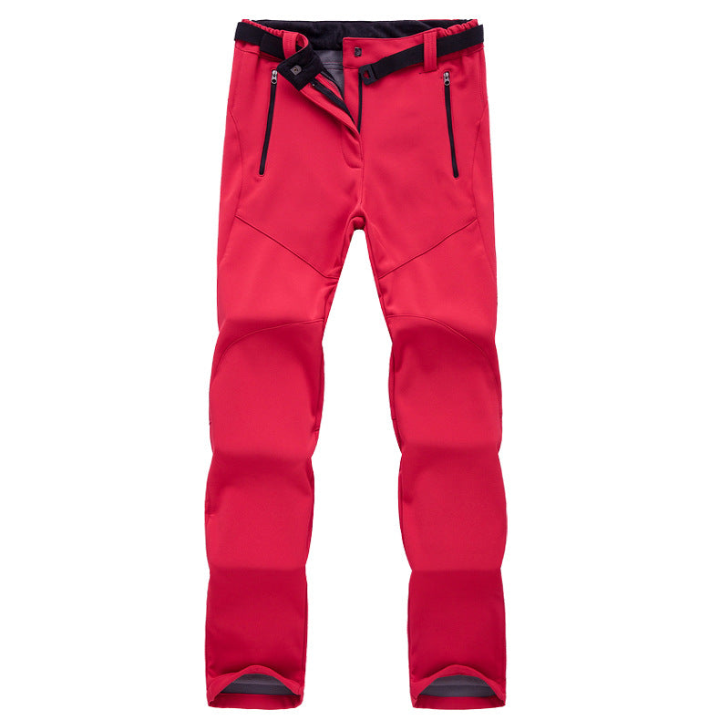 Red softshell outdoor pants with black adjustable waistband and zippered pockets