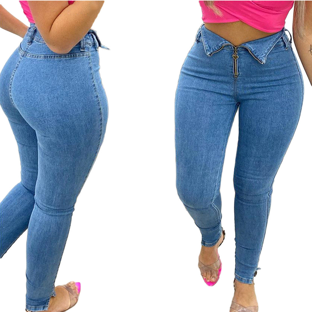 Woman wearing high-waisted blue skinny jeans with heart zipper detail and pink crop top