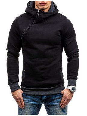 Man wearing black asymmetrical zip hoodie with gray cuffs and blue jeans