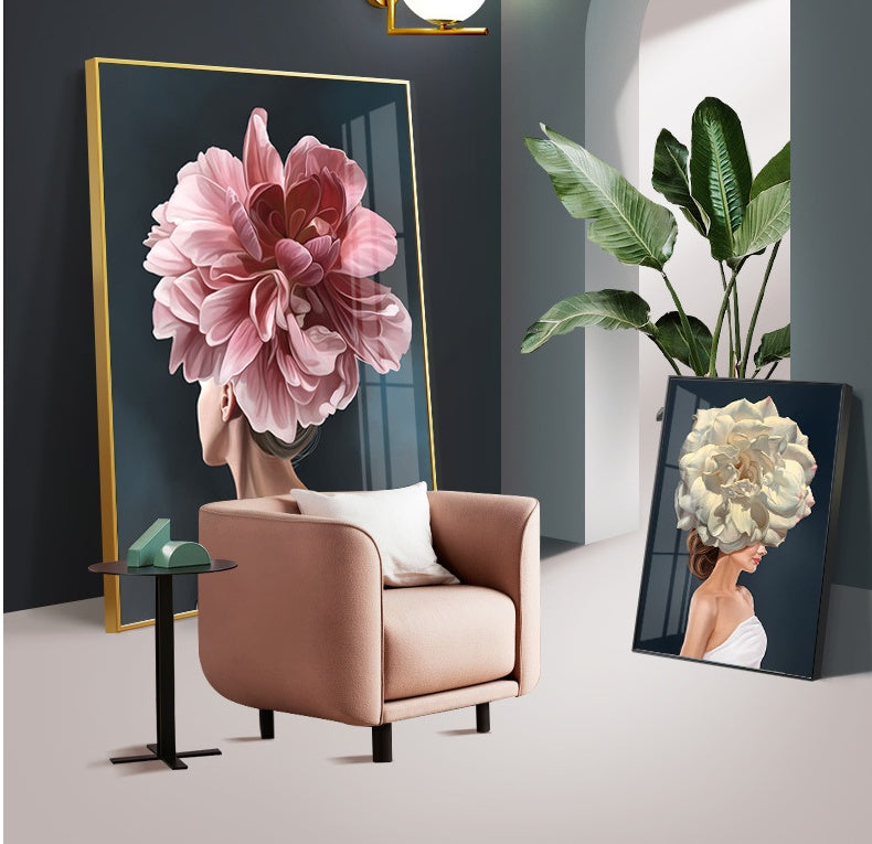 Modern interior with pink armchair, side table, large floral head portraits, and green plant under archway