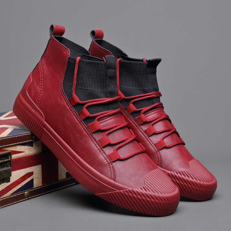 Red high-top casual sneakers with black elastic ankle collars and red laces on a Union Jack box