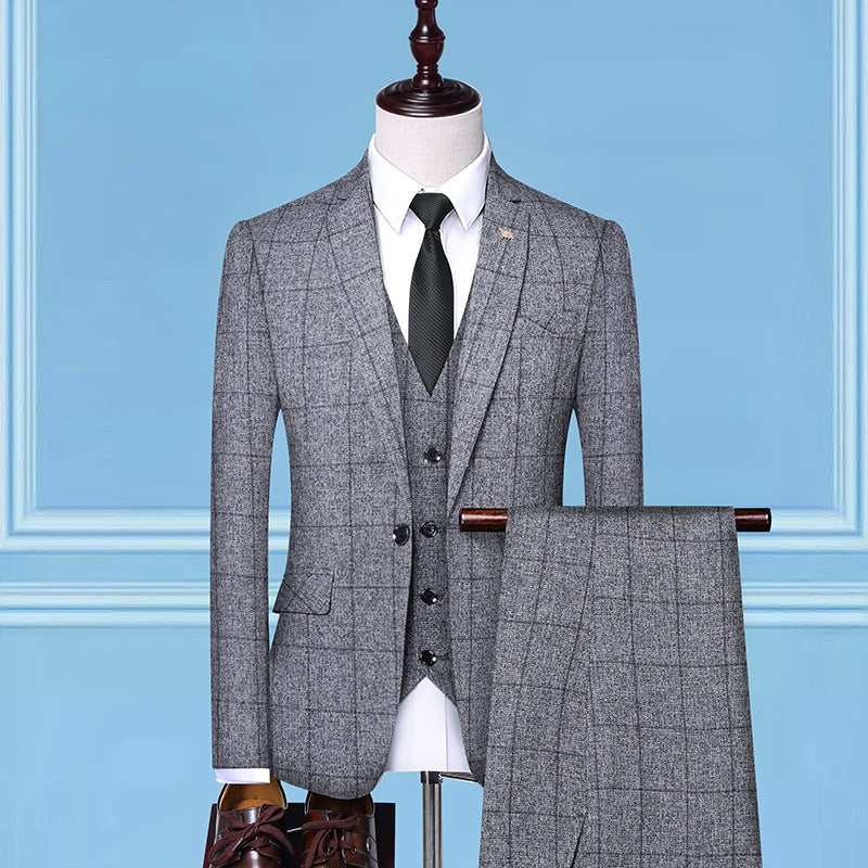 Men's grey windowpane check three-piece suit with black tie on mannequin, blue background