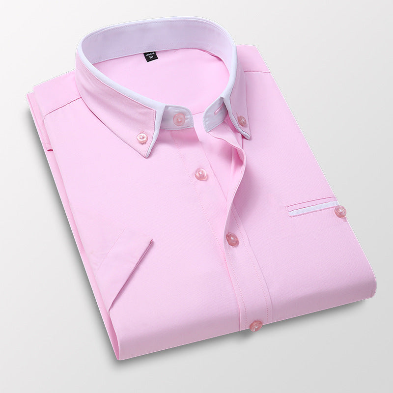 Folded pink dress shirt with white button-down collar and pink buttons on white background