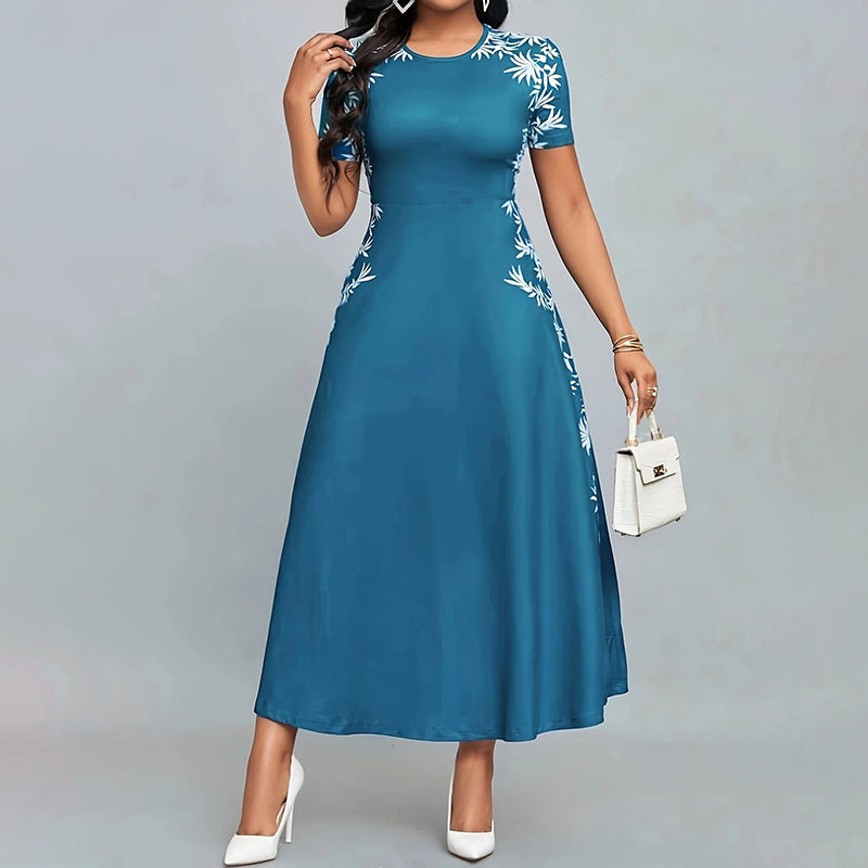 Woman wearing blue midi dress with white floral embroidery, holding white handbag, white heels
