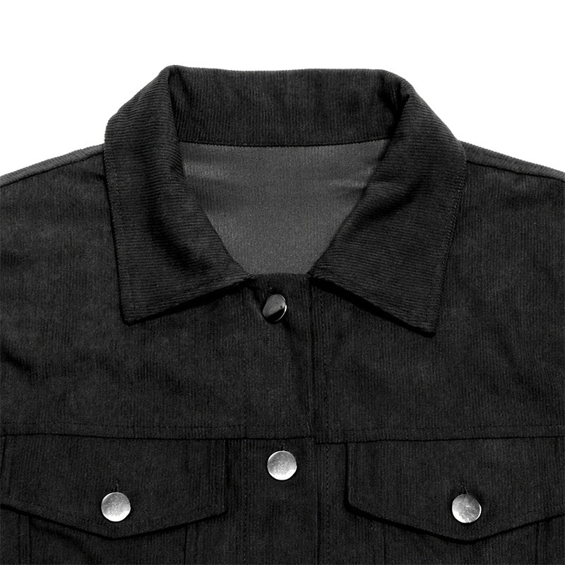 Close-up of black corduroy jacket collar with silver snap buttons and chest pockets