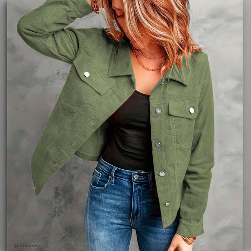 Woman wearing olive green button-up jacket with chest pockets, black top, and blue jeans against gray background