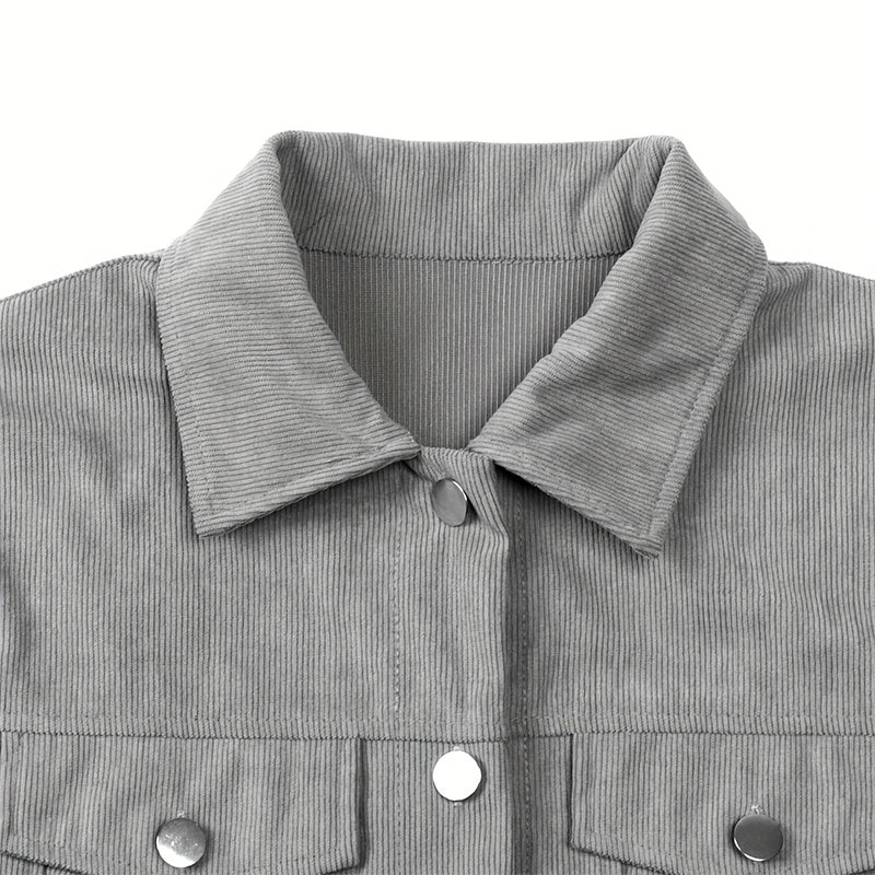 Close-up of grey corduroy jacket collar with shiny metal snap buttons and textured fabric