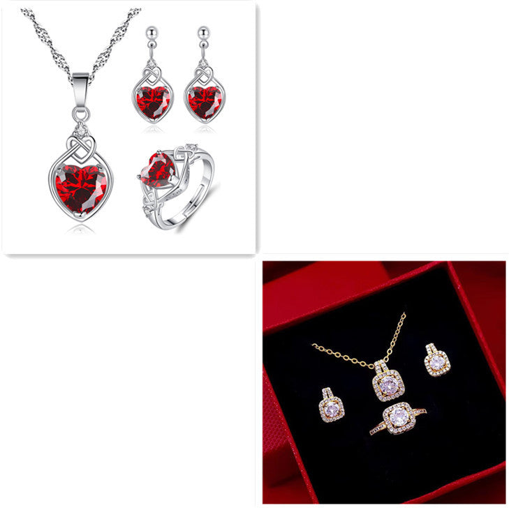 Two jewelry sets: silver heart-shaped red gemstone necklace, earrings, ring; gold square clear stone set in box