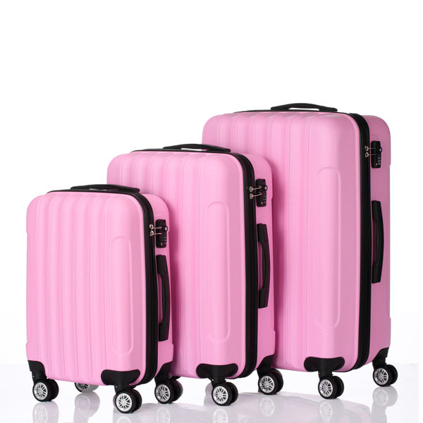 Set of three pink hard-shell suitcases with black handles and spinner wheels on white background
