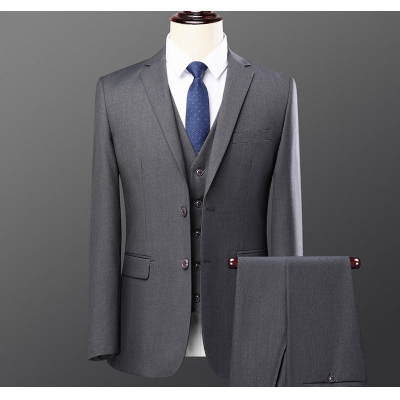 Gray three-piece men's suit with jacket, vest, trousers, white shirt, and blue tie on mannequin
