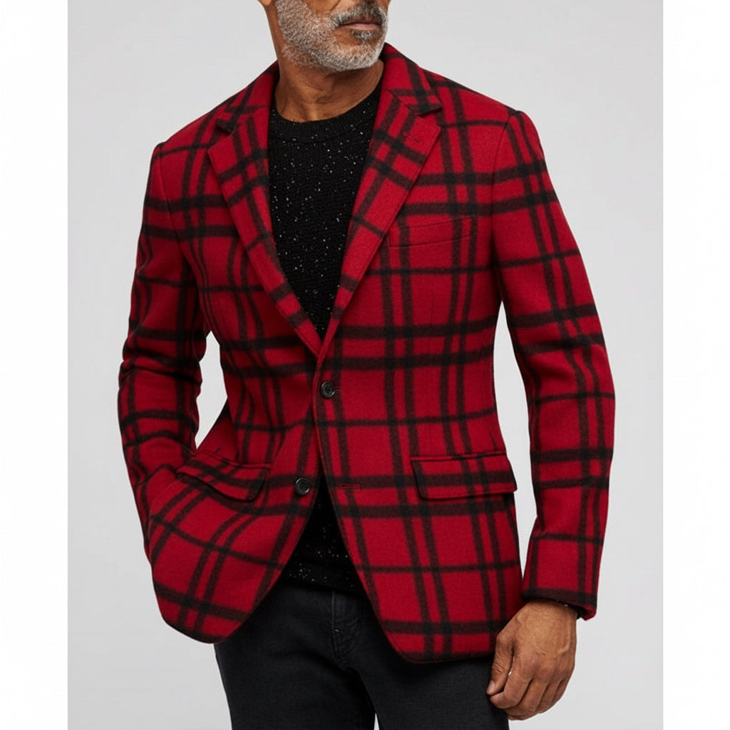 Man wearing red and black plaid blazer over black speckled sweater and black pants