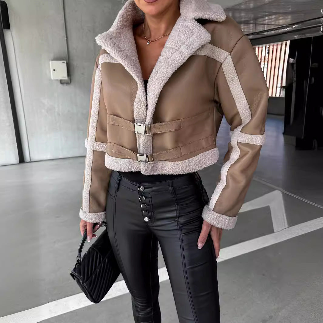 Woman wearing cropped beige shearling jacket with buckles and high-waisted black leather pants