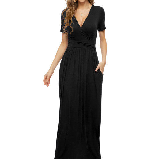 Woman wearing a black V-neck short sleeve maxi dress with a fitted waist and side pockets