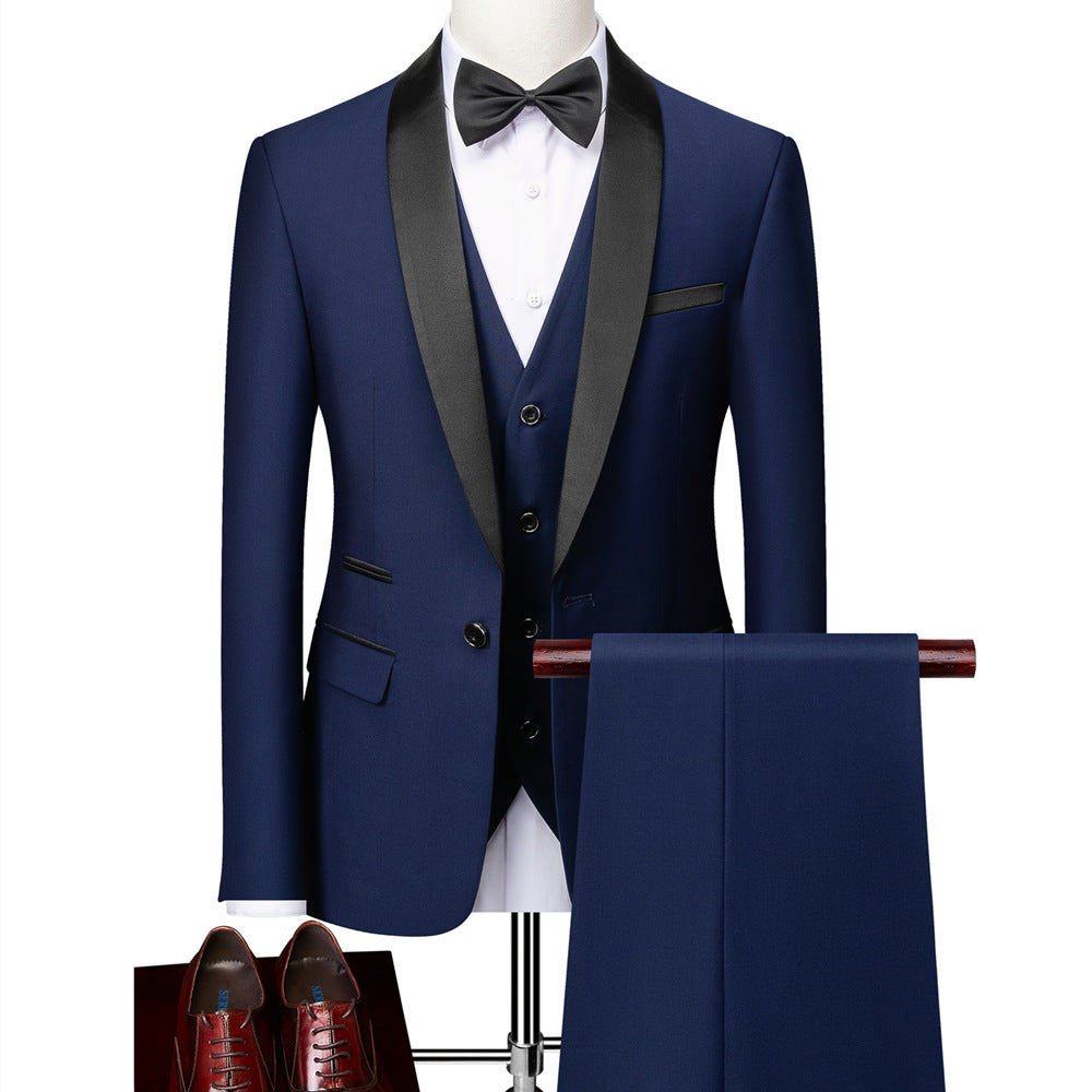 Navy blue tuxedo with black satin shawl collar, matching vest, black bow tie, white shirt, and brown dress shoes