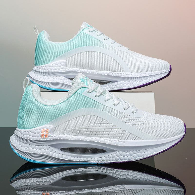 Pair of white and light blue sporty running shoes with textured soles and air cushioning, reflected on glossy surface