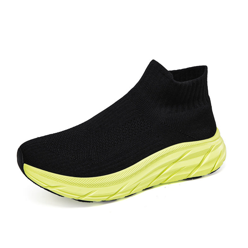 black knit sock-style sneaker with neon yellow textured sole on white background