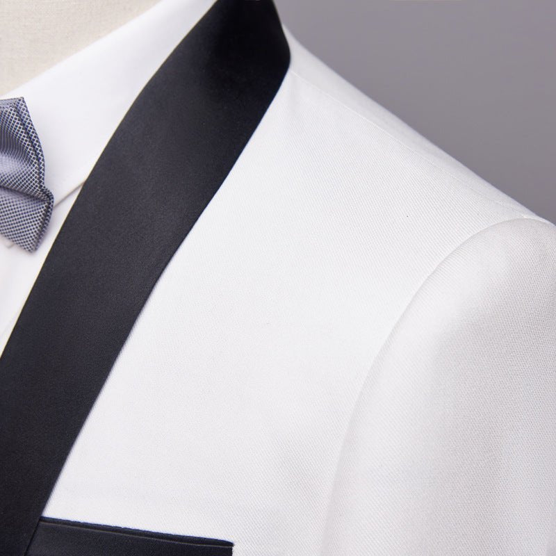 Close-up of white men's tuxedo jacket with black satin shawl lapel and blue bow tie