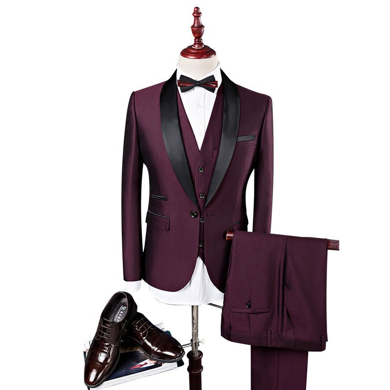 Men's three-piece dark burgundy wedding suit with black satin lapel, white shirt, black bow tie, and black dress shoes