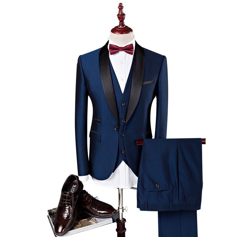 Men's navy blue three-piece wedding suit with black satin lapels, white shirt, red bow tie, and brown dress shoes