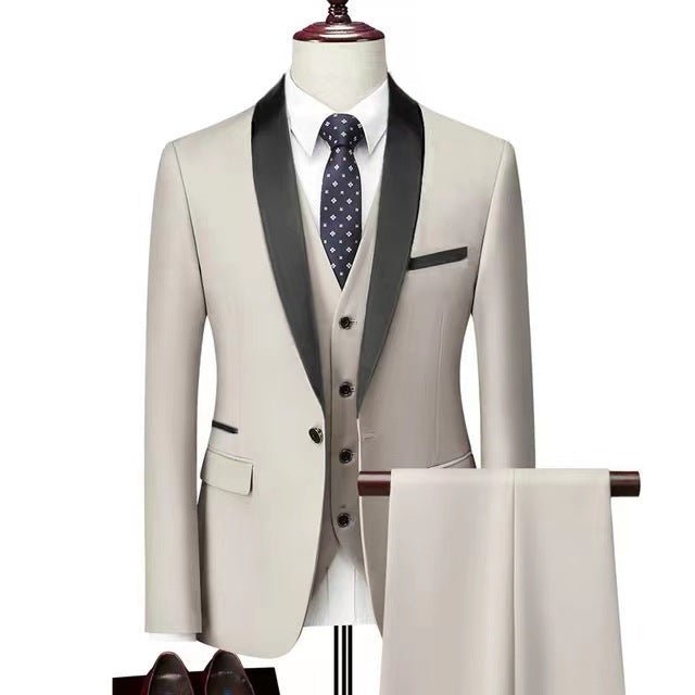 men's beige three-piece wedding suit with black satin lapels, white shirt, patterned tie, and matching trousers