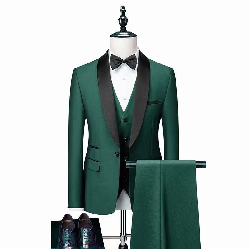 Men's three-piece dark green wedding suit with black lapel, white shirt, black bow tie, and matching pants displayed on mannequin