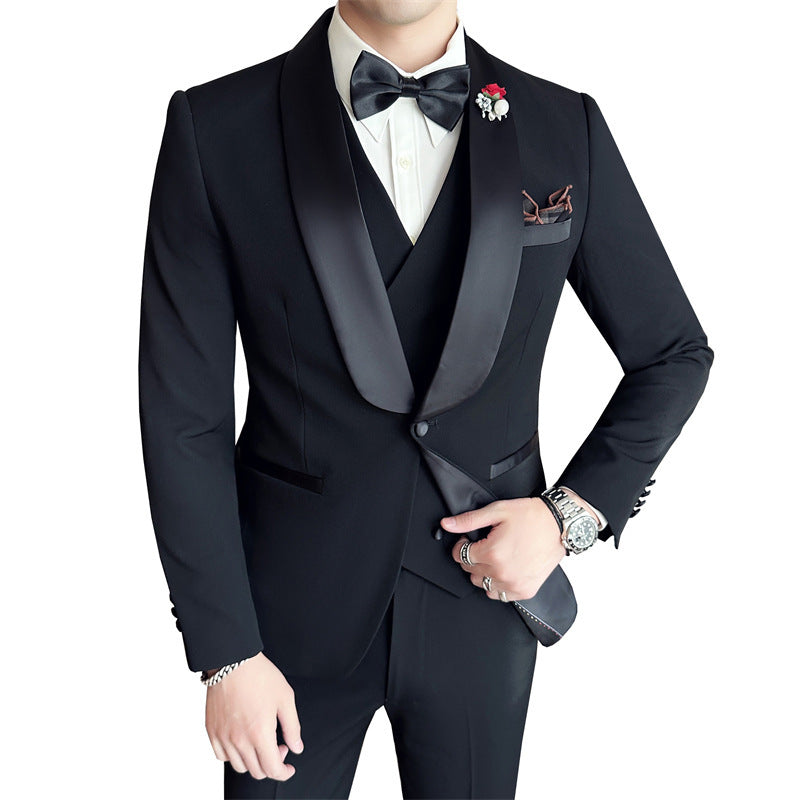 Man wearing black tuxedo with satin shawl lapels, white shirt, black bow tie, and boutonniere
