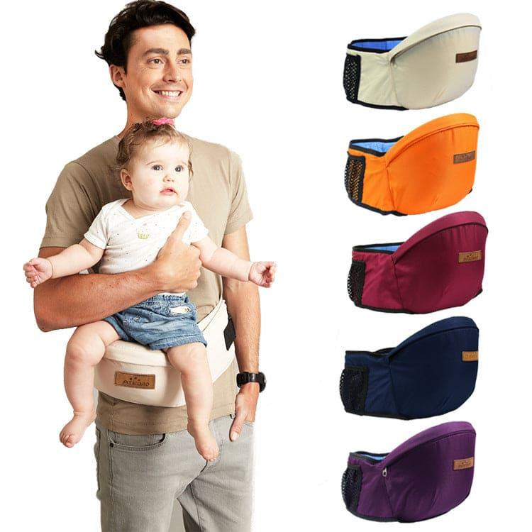 Man carrying baby using beige ergonomic baby hip seat carrier with additional carriers in orange, burgundy, navy, and purple