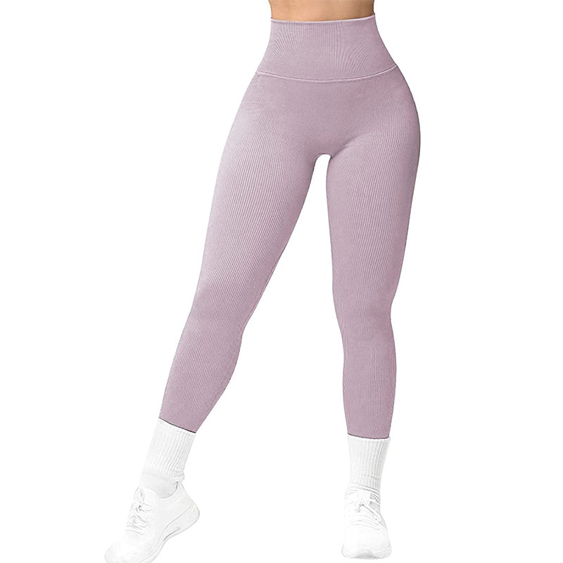 High-waisted lilac ribbed leggings paired with white socks and white sneakers on model