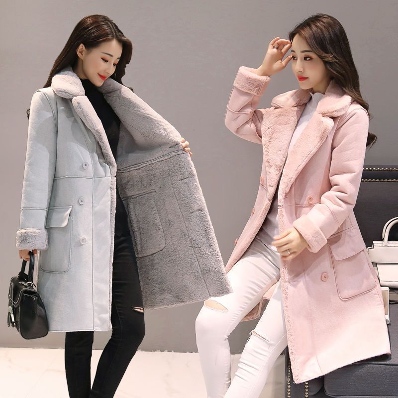 Two women modeling long winter shearling coats in grey and pink with fur collar and cuffs
