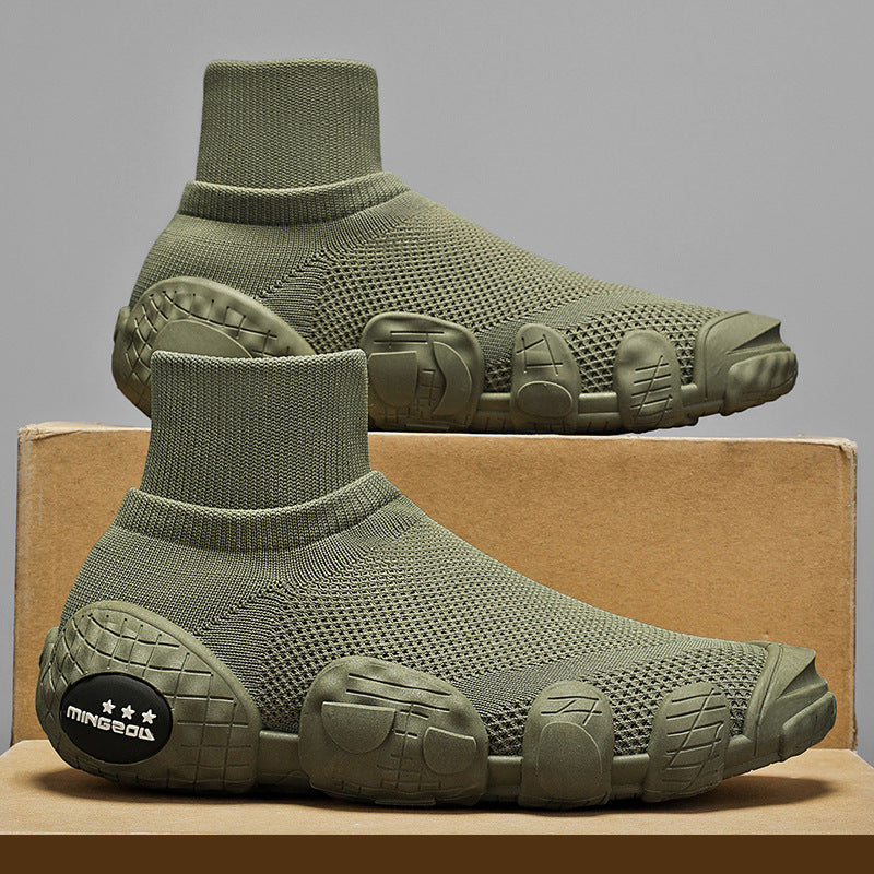 Olive green sock-style sneakers with textured knit upper and unique segmented sole on a cardboard box