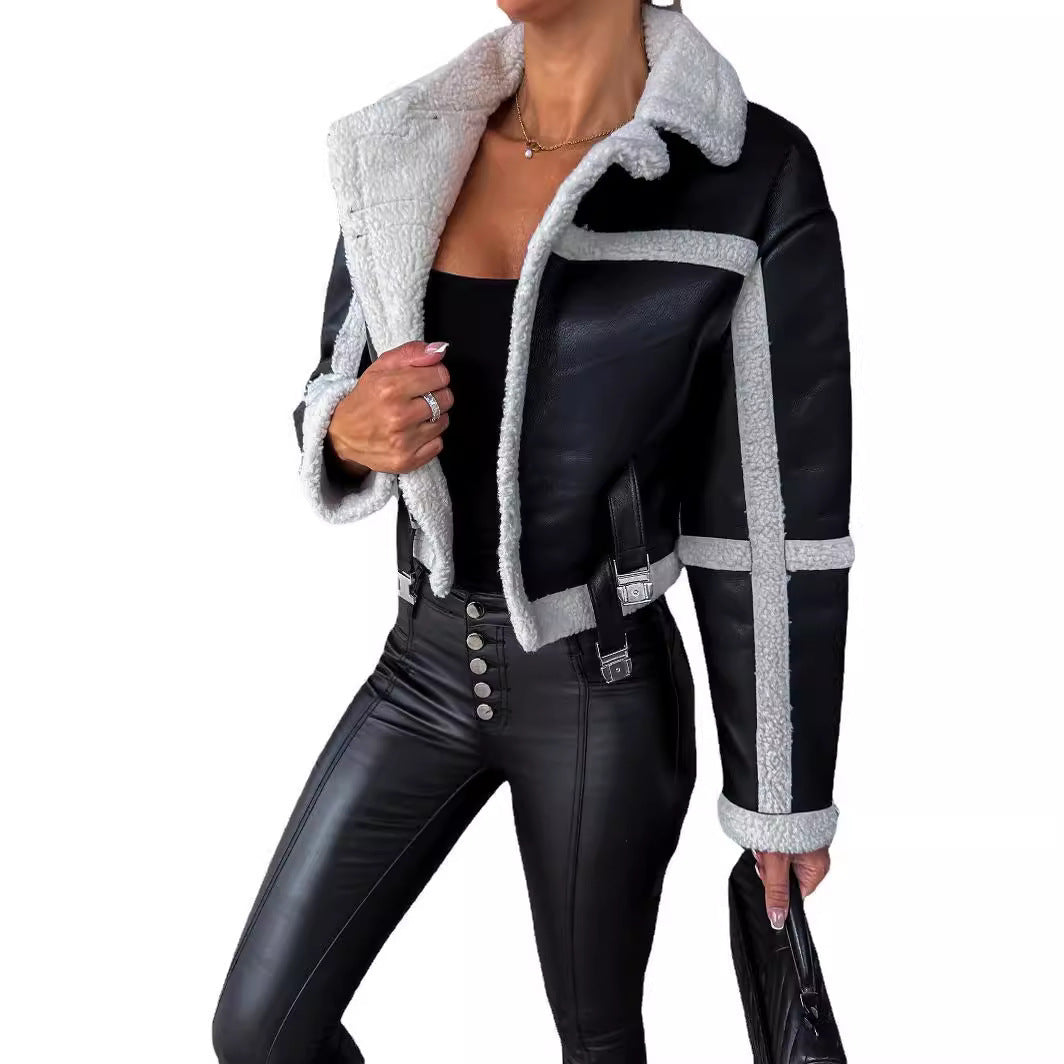 Woman wearing black faux leather cropped jacket with white shearling trim and black high-waist leather pants